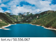 Blue sky and turquoise sea landscape with mountains and white clouds. Стоковое фото, агентство Ingram Publishing / Фотобанк Лори