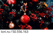 3d Rendering decorating the Christmas tree in red, assorted balls and wooden figurines. Стоковое фото, агентство Ingram Publishing / Фотобанк Лори