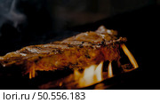 Beef cooked on the grill. Court entrails with flames of fire. Стоковое фото, агентство Ingram Publishing / Фотобанк Лори