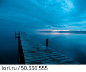 Perfect symmetry, a wooden jetty on a Lake at sunrise in the morning. Стоковое фото, агентство Ingram Publishing / Фотобанк Лори