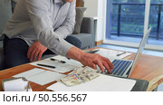 Businessman reviewing data in financial statement and assessment business. Accounting , Accountancy, Bookkeeping Concept. Стоковое фото, агентство Ingram Publishing / Фотобанк Лори