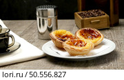 Pasteis de Nata or Portuguese Custard Tarts with black coffee on wooden table. Стоковое фото, агентство Ingram Publishing / Фотобанк Лори