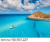 Aerial view of luxury yachts on blue sea at sunny day in summer. Sardinia, Italy. Tropical seascape with speed boats, yachts, sea lagoon, mountain, transparent water, sky with clouds. Top drone view. Стоковое фото, агентство Ingram Publishing / Фотобанк Лори