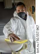 Surfboard manufacturing, Shaper working on board details. Concept of industrial manufacturing, qualified professional, occupation and employment. Стоковое фото, агентство Ingram Publishing / Фотобанк Лори