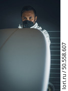 Surfboard manufacturing, Shaper working on board details. Concept of industrial manufacturing, qualified professional, occupation and employment. Стоковое фото, агентство Ingram Publishing / Фотобанк Лори