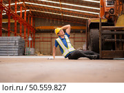 Young man working in a steel industry factory. He was critically hurt when a forklift ran over his leg and had to be transported to the hospital. Стоковое фото, агентство Ingram Publishing / Фотобанк Лори