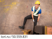 Young man working in a steel industry factory. He was critically hurt when a forklift ran over his leg and had to be transported to the hospital. Стоковое фото, агентство Ingram Publishing / Фотобанк Лори