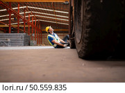 Young man working in a steel industry factory. He was critically hurt when a forklift ran over his leg and had to be transported to the hospital. Стоковое фото, агентство Ingram Publishing / Фотобанк Лори