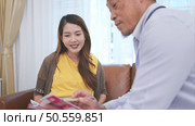 Asian pregnant woman visit gynecologist doctor at medical clinic for pregnancy consultant. Doctor examine pregnant belly for baby and mother healthcare check up. Стоковое фото, агентство Ingram Publishing / Фотобанк Лори