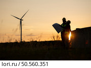 Silhouette of Engineer in charge of wind energy against a background of wind turbines. Стоковое фото, агентство Ingram Publishing / Фотобанк Лори