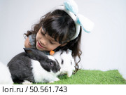 Easter bunny fun with little children the beauty of friendship between humans and animals. Стоковое фото, агентство Ingram Publishing / Фотобанк Лори
