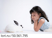 Smiling little girl and with their beloved rabbit, showcasing the beauty of friendship between humans and animals. Стоковое фото, агентство Ingram Publishing / Фотобанк Лори