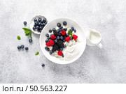 Cheese cottage with yogurt and fresh berries. Curd with blueberry, raspberry and blackberry, top view. Стоковое фото, агентство Ingram Publishing / Фотобанк Лори