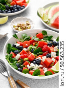 Watermelon and feta cheese salad with blueberry, raspberry, pistachios and fresh greens. Стоковое фото, агентство Ingram Publishing / Фотобанк Лори