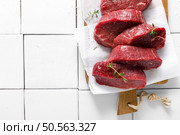 Beef. Raw beef tenderloin meat, beef steaks with ingredients for cooking. Top view. Стоковое фото, агентство Ingram Publishing / Фотобанк Лори