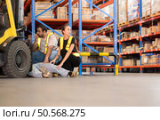A warehouse employee suffered a leg accident at work. Стоковое фото, агентство Ingram Publishing / Фотобанк Лори
