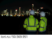 Both of Petroleum engineer is on a mission to inspect oil distillation at a huge oil refinery. Стоковое фото, агентство Ingram Publishing / Фотобанк Лори
