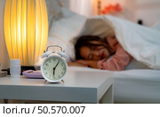 Asian young woman on the bed in the bedroom trying to wake up and prepare for work. Стоковое фото, агентство Ingram Publishing / Фотобанк Лори