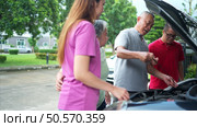 A brother and sister help each other execute a basic engine check on their parents’ automobile. Стоковое фото, агентство Ingram Publishing / Фотобанк Лори