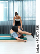 A young man and a young woman are doing pilates exercises on a pilates reformer. Стоковое фото, агентство Ingram Publishing / Фотобанк Лори