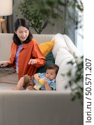 Mother and son play together after dad comes home from work. Стоковое фото, агентство Ingram Publishing / Фотобанк Лори