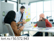 Multiethnic young business people working together in modern office, Collaborate to designing an application for use on the internet network. Стоковое фото, агентство Ingram Publishing / Фотобанк Лори