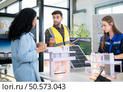 Engineers, architects, and designers collaborate to design a building that employs natural energy. Стоковое фото, агентство Ingram Publishing / Фотобанк Лори