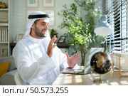 Portrait of young Arabic businessman working on laptop at home. Стоковое фото, агентство Ingram Publishing / Фотобанк Лори