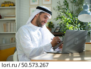 Portrait of young Arabic businessman working on laptop at home. Стоковое фото, агентство Ingram Publishing / Фотобанк Лори