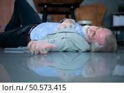 An elderly businessman fell to the floor with sudden heart failure at work. Стоковое фото, агентство Ingram Publishing / Фотобанк Лори