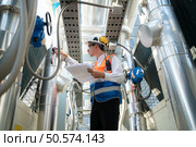 Engineers inspect the completed air conditioning and water systems to continue verifying their functionality. Стоковое фото, агентство Ingram Publishing / Фотобанк Лори