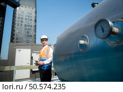 Engineers inspect the completed air conditioning and water systems to continue verifying their functionality. Стоковое фото, агентство Ingram Publishing / Фотобанк Лори