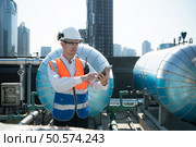 Engineers inspect the completed air conditioning and water systems to continue verifying their functionality. Стоковое фото, агентство Ingram Publishing / Фотобанк Лори