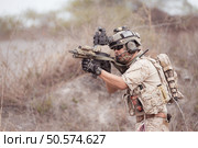 Soldiers in camouflage military uniforms carrying weapons, Reconnaissance missions in rugged mountains, Assault infantry battle training. Стоковое фото, агентство Ingram Publishing / Фотобанк Лори