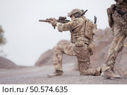 Soldiers in camouflage military uniforms carrying weapons, Reconnaissance missions in rugged mountains, Assault infantry battle training. Стоковое фото, агентство Ingram Publishing / Фотобанк Лори