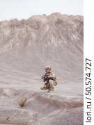 Soldiers in camouflage military uniforms carrying weapons, Reconnaissance missions in rugged mountains, Assault infantry battle training. Стоковое фото, агентство Ingram Publishing / Фотобанк Лори