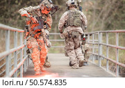 Soldiers in camouflage military uniforms carrying weapons, Reconnaissance missions in the tropical forest area, Assault infantry battle training. Стоковое фото, агентство Ingram Publishing / Фотобанк Лори