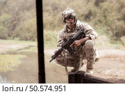 Soldiers in camouflage military uniforms carrying weapons, Reconnaissance missions in the tropical forest area, Assault infantry battle training. Стоковое фото, агентство Ingram Publishing / Фотобанк Лори