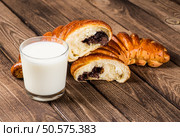 Tasty croissants with spikelets on grey wooden background. Стоковое фото, агентство Ingram Publishing / Фотобанк Лори