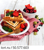 waffles with fresh berries on a old wooden table. Стоковое фото, агентство Ingram Publishing / Фотобанк Лори