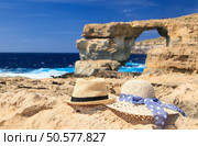 two hats at Azure Window in Gozo island, vacation in Malta concept. two hats at Azure Window in Gozo island. Стоковое фото, агентство Ingram Publishing / Фотобанк Лори
