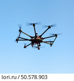 Drone on a background of a beautiful sunset. UAV in flight. Quadrocopters on radio.. Oktokopter, copter, drone. Стоковое фото, агентство Ingram Publishing / Фотобанк Лори