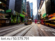 Transportation in Hong Kong Features Trams and Buses on a Busy Street (2024 год). Редакционное фото, фотограф Aleksandr Golubev / Фотобанк Лори