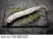 Traditional italian salami on dark background. Salami on dark background. Стоковое фото, агентство Ingram Publishing / Фотобанк Лори