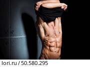 Muscular and sexy torso of young sport man. Attractive bodybuilder body with perfect abs, chest, bicep, triceps. Muscular and sexy torso of young sport man. Bodybuilder body with perfect abs, chest, bicep, triceps. Hunk taking off his shirt. Стоковое фото, агентство Ingram Publishing / Фотобанк Лори