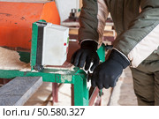 Carpenter working at sawmill, closeup photo. Carpenter working at sawmill . Стоковое фото, агентство Ingram Publishing / Фотобанк Лори