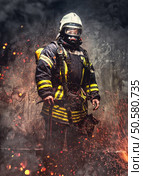 Rescue man in firefighter uniform and oxygen mask. Стоковое фото, агентство Ingram Publishing / Фотобанк Лори