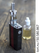 E-cigarette or vaping device on wooden surface, natural light. Стоковое фото, агентство Ingram Publishing / Фотобанк Лори