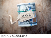 Make More Money,  inscription, on the  background wooden table and one hundred dollar bills. Стоковое фото, агентство Ingram Publishing / Фотобанк Лори