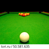 A green cloth billiards or pool table with english league red and yellow balls. Стоковое фото, агентство Ingram Publishing / Фотобанк Лори